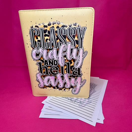 Champagne-gold A5 faux leather binder with 'Classy Crafty and Hella Sassy' typography over a leopard print splash