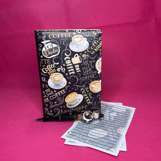 Black A6 faux leather binder covered in gold and cream chalkboard-style coffee illustrations and lettering: lattes, Americano, Coffee Time, But First Coffee