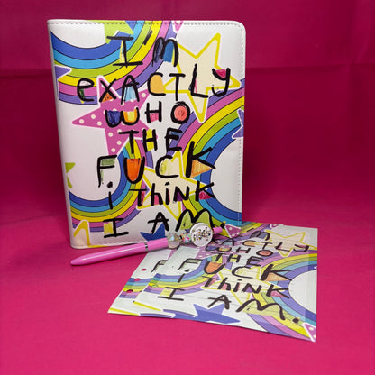 Full-bleed A5 faux leather binder with 'I'm exactly who the fuck I think I am' in raw black block letters over a rainbow star-burst background