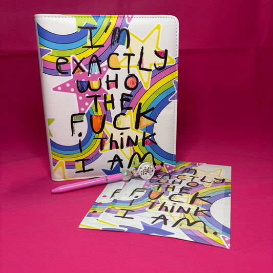 Full-bleed A5 faux leather binder with 'I'm exactly who the fuck I think I am' in raw black block letters over a rainbow star-burst background