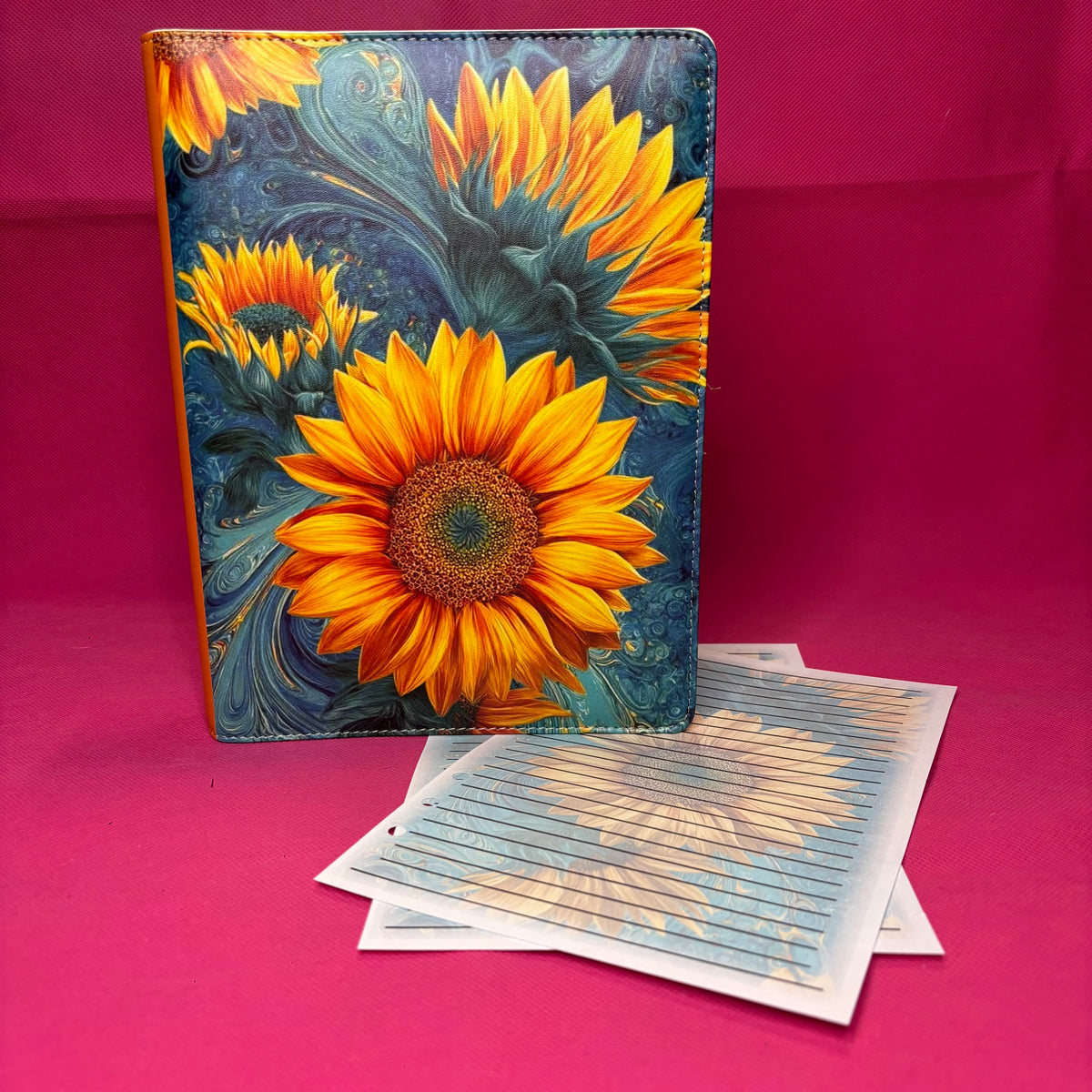Blue and gold marbled A5 faux leather binder with vibrant oil-painted sunflowers bursting across the cover