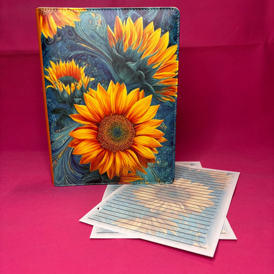 Blue and gold marbled A5 faux leather binder with vibrant oil-painted sunflowers bursting across the cover