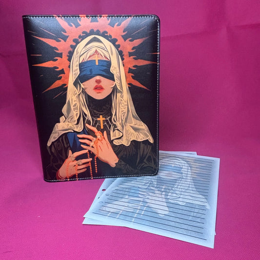 Black A5 faux leather binder with a hooded blindfolded nun figure crowned by a red-orange halo, holding a rosary