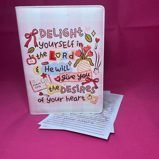 Pink A5 faux leather binder with Psalm 37:4 'Delight yourself in the Lord & He will give you the desires of your heart' in doodle-diary style lettering with tulips and bows