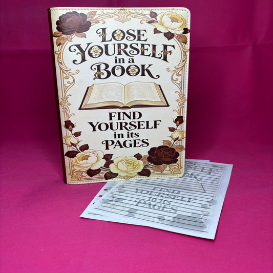 Cream A5 faux leather binder with vintage art-nouveau frame, open book at center, roses at every corner, and 'Lose Yourself in a Book, Find Yourself in its Pages' in serif ink