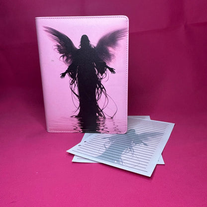 Pink A5 faux leather binder with a black-winged silhouette figure standing in reflective water, hair trailing down